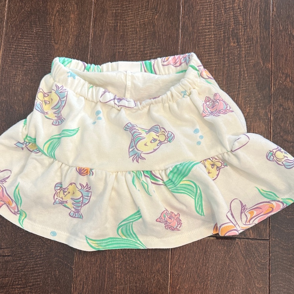 3/$15 Disney Little Mermaid Cream Skirt with Pastel Green, Purple, Yellow